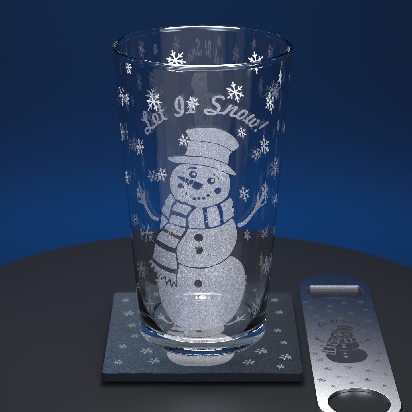Pint glass set comprising glass, slate coaster and stainless steel bottle opener engraved with a cartoon snowman and Let it Snow text