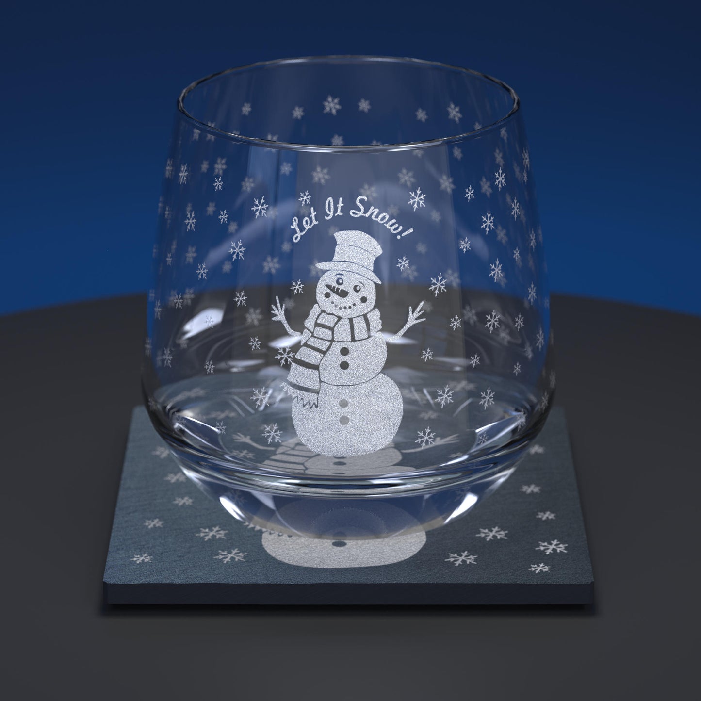 Glass whiskey tumbler set including a glass and slate coaster engraved with a cartoon snowman and Let it Snow text