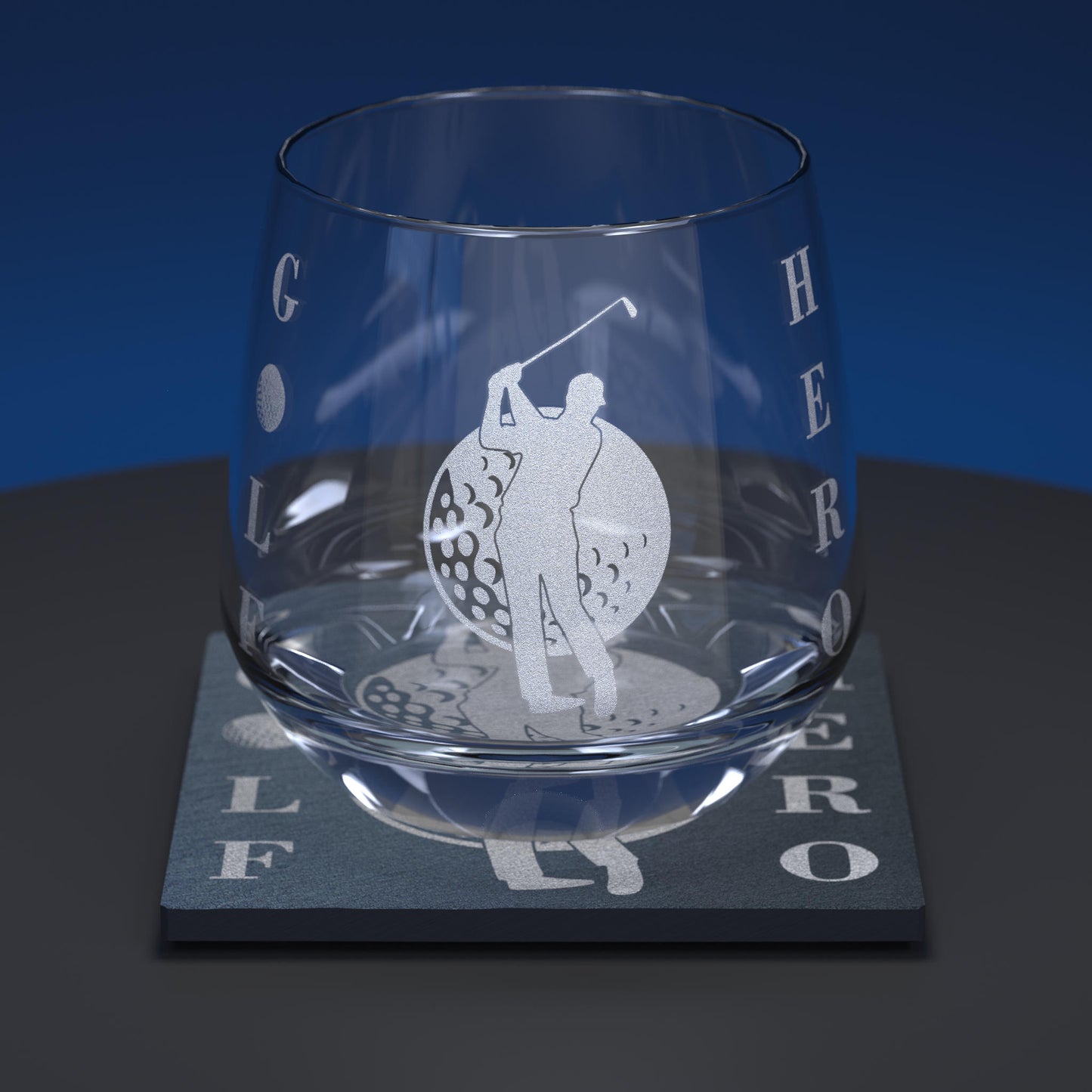 Glass whiskey tumbler engraved with a golfer and golf ball with the words Golf Hero together with matching slate coaster