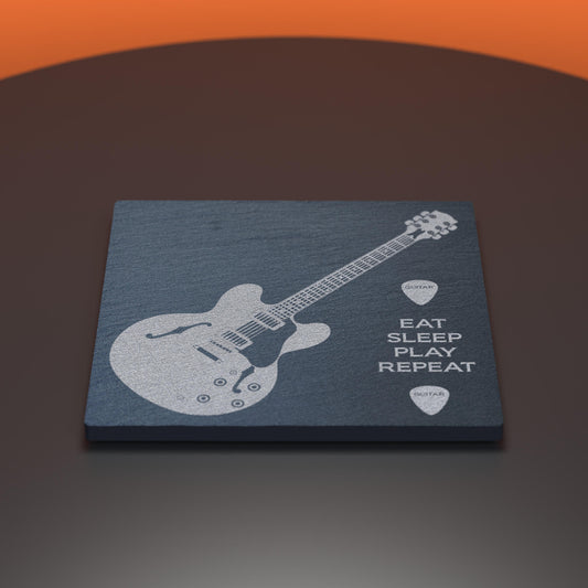 Slate coaster engraved with an electric guitar with the words Eat, Sleep, Play, Repeat
